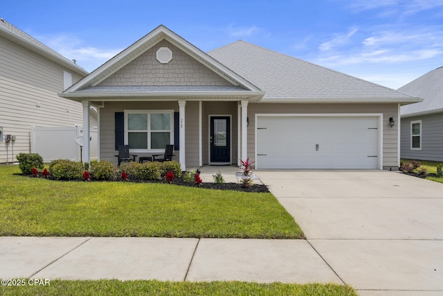 view of front facade with a garage, a front lawn, concrete driveway, and covered porch