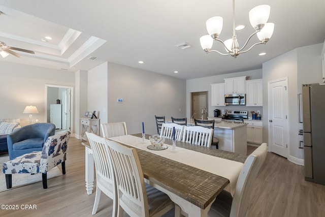 dining room with light wood finished floors and recessed lighting
