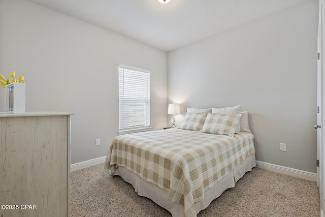 bedroom with baseboards and light carpet