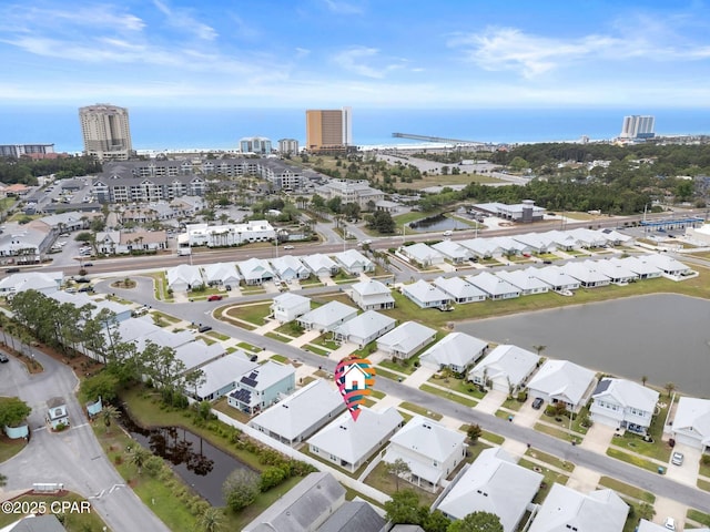 drone / aerial view featuring a city view and a water view