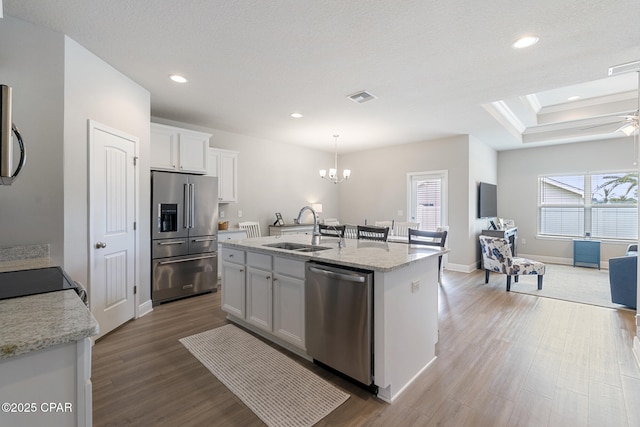 kitchen featuring wood finished floors, visible vents, a sink, and appliances with stainless steel finishes
