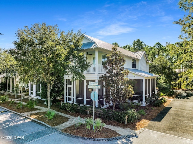 view of front of home featuring a sunroom and metal roof