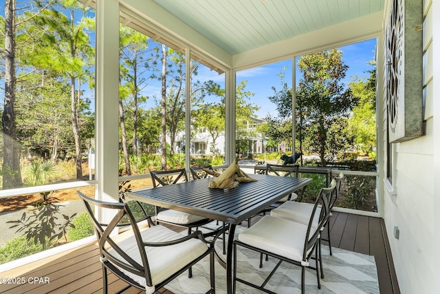 sunroom featuring a wealth of natural light and outdoor dining area