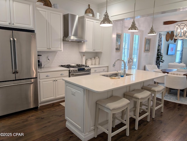 44 E Royal Fern Way, Santa Rosa Beach, FL 32459 - kitchen featuring stainless steel appliances, wall chimney range hood, a sink, dark wood-type flooring, and backsplash