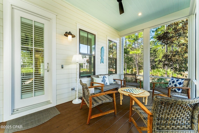sunroom / solarium featuring a ceiling fan