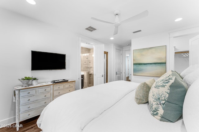 bedroom featuring baseboards, dark wood-style flooring, ensuite bathroom, and visible vents