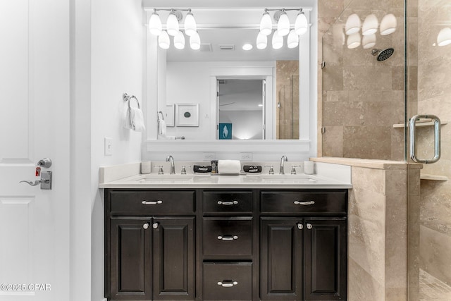 full bathroom with a shower stall, a sink, and double vanity