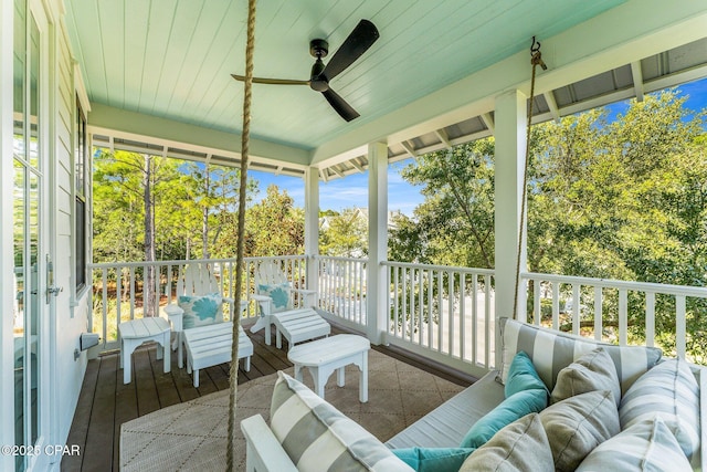 sunroom with an outdoor living space and ceiling fan