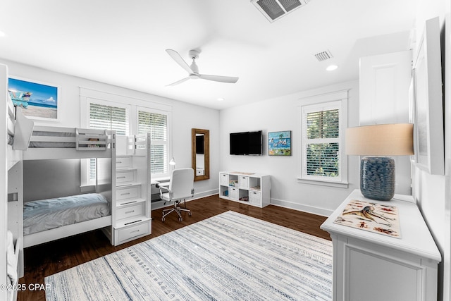 bedroom featuring multiple windows, visible vents, and dark wood finished floors