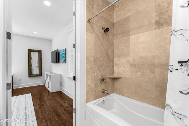 full bath featuring shower / tub combo, baseboards, wood finished floors, and recessed lighting