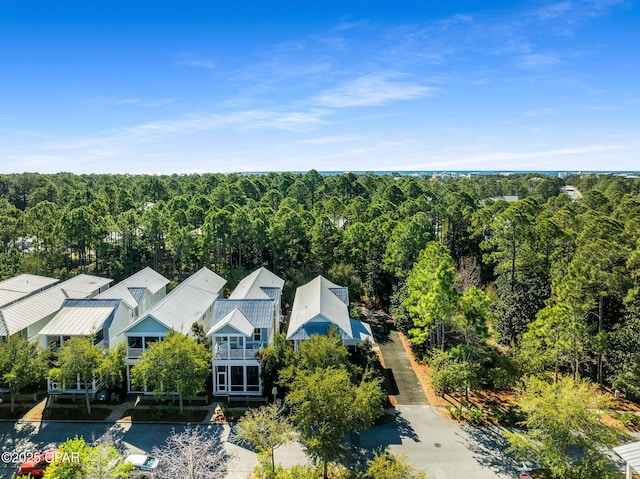 birds eye view of property featuring a view of trees