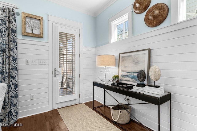 interior space with crown molding and wood finished floors