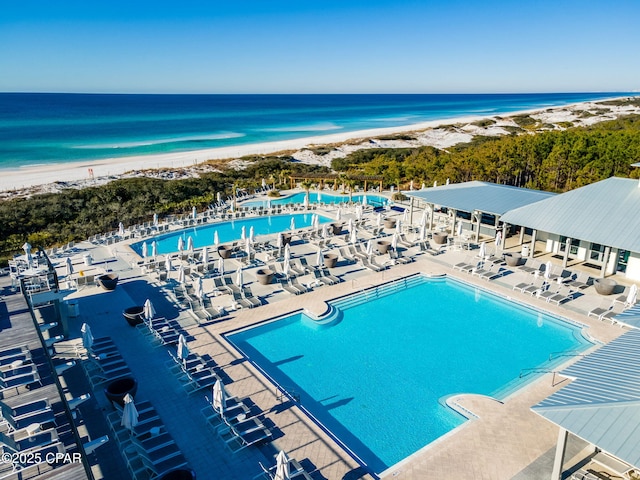 community pool featuring a beach view and a water view