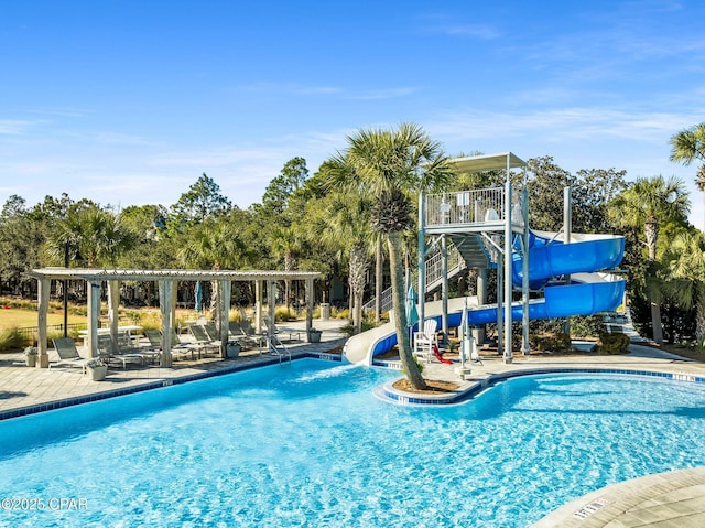 pool with a patio area and a water slide