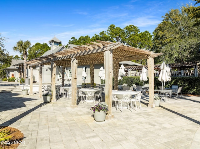 view of patio featuring a pergola and outdoor dining area