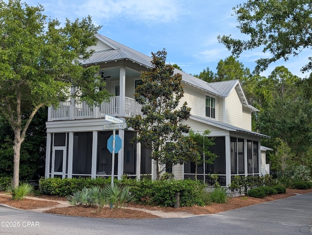 44 E Royal Fern Way, Santa Rosa Beach, FL 32459 - view of side of home featuring a sunroom, a balcony, and metal roof