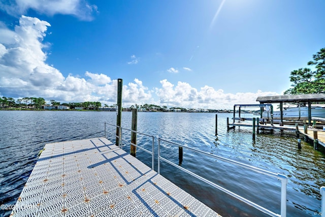 dock area with boat lift and a water view