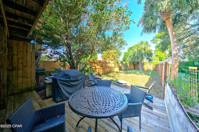 deck featuring outdoor dining space and area for grilling