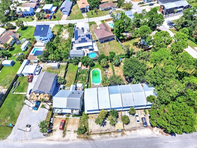 aerial view of property's location featuring nearby suburban area and a pool