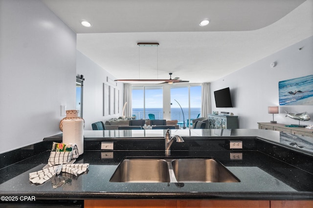 15625 Front Beach Rd Unit 1405, Panama City Beach, FL 32413 - kitchen featuring a ceiling fan, a sink, open floor plan, dark stone counters, and black dishwasher