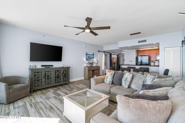 15625 Front Beach Rd Unit 1405, Panama City Beach, FL 32413 - living room with light wood-style floors, baseboards, ceiling fan, and visible vents