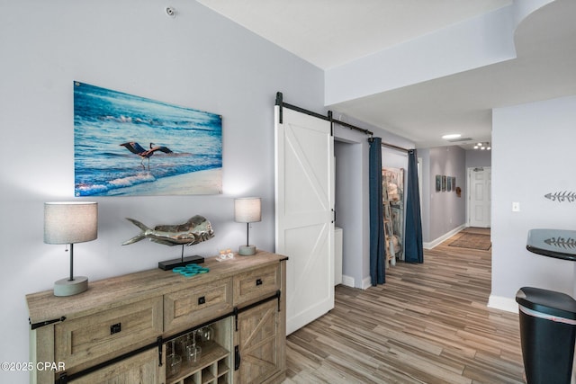 15625 Front Beach Rd Unit 1405, Panama City Beach, FL 32413 - hall with baseboards, light wood-style flooring, and a barn door