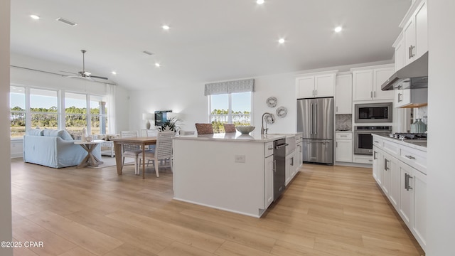 934 Crystal Bayou Blvd, Panama City Beach, FL 32407 - kitchen with stainless steel appliances, under cabinet range hood, a ceiling fan, white cabinetry, and light wood-style floors