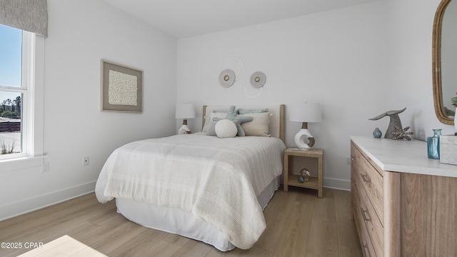 934 Crystal Bayou Blvd, Panama City Beach, FL 32407 - bedroom with light wood finished floors and baseboards