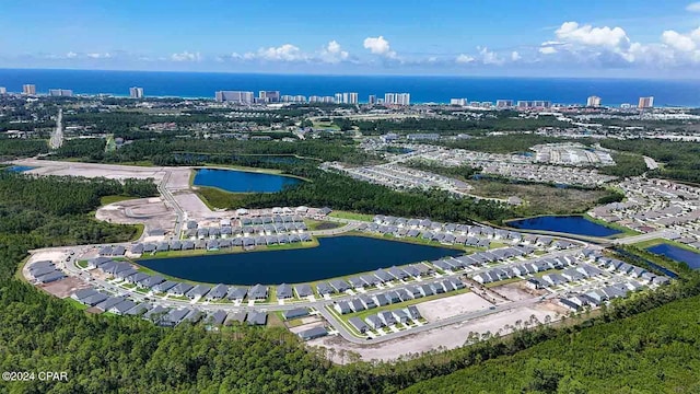 birds eye view of property with a view of city and a water view