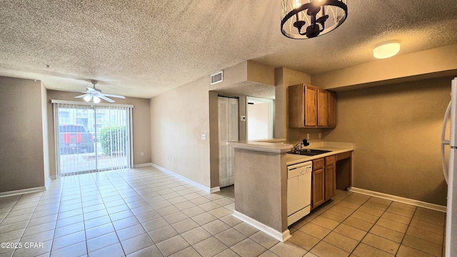 4075 Dancing Cloud Ct Unit 197, Destin, FL 32541 - kitchen featuring a textured ceiling, white appliances, brown cabinetry, light countertops, and light tile patterned floors