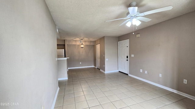 4075 Dancing Cloud Ct Unit 197, Destin, FL 32541 - empty room featuring a textured ceiling, a ceiling fan, baseboards, and light tile patterned floors