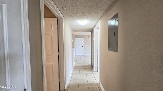 4075 Dancing Cloud Ct Unit 197, Destin, FL 32541 - hall featuring baseboards, a textured ceiling, electric panel, and light tile patterned floors