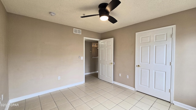 4075 Dancing Cloud Ct Unit 197, Destin, FL 32541 - unfurnished bedroom featuring visible vents, a ceiling fan, light tile patterned floors, baseboards, and a textured ceiling