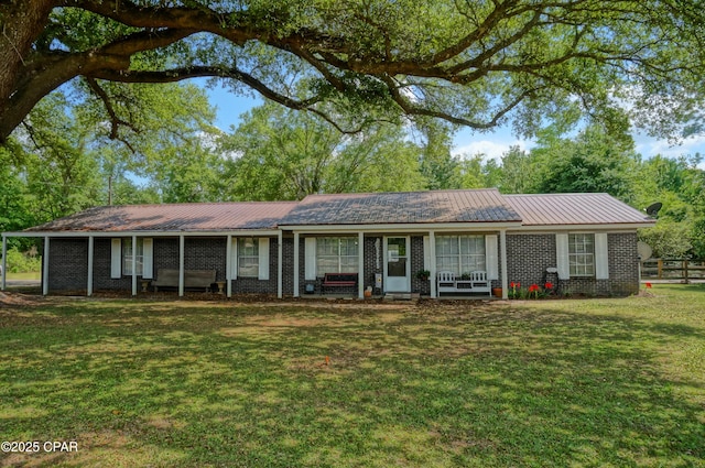5585 Suncrest Rd, Marianna, FL 32448 - single story home featuring metal roof, a front lawn, and brick siding