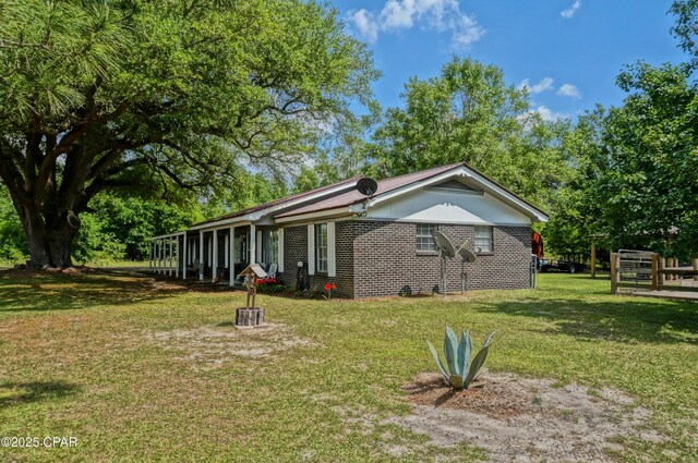 5585 Suncrest Rd, Marianna, FL 32448 - view of front of house featuring a front yard and brick siding