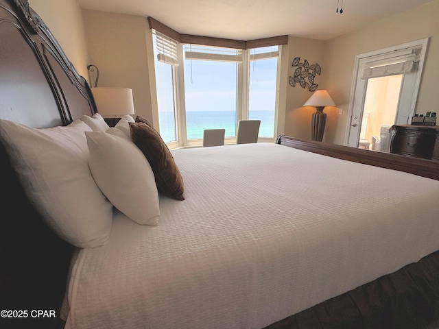 bedroom featuring a water view