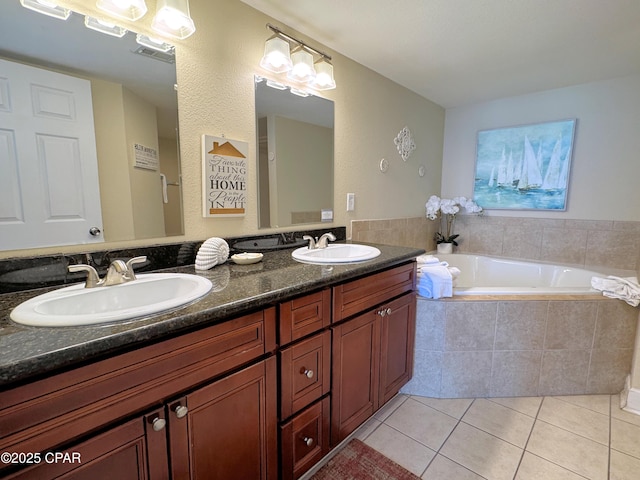 bathroom featuring tile patterned flooring, a sink, a garden tub, and double vanity