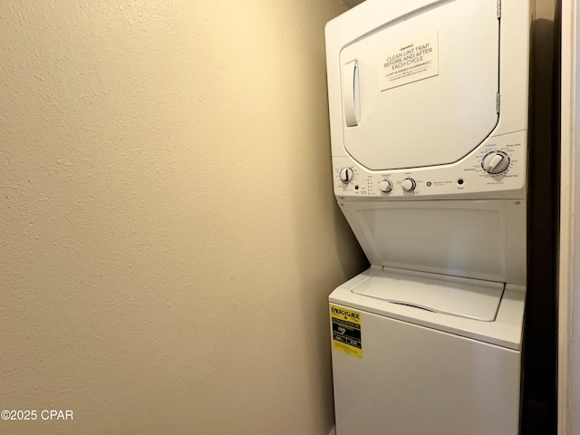 washroom featuring stacked washing maching and dryer and laundry area