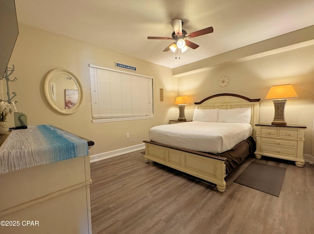 bedroom featuring baseboards, ceiling fan, and wood finished floors