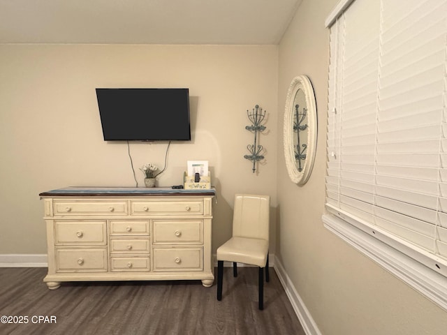 sitting room featuring baseboards and dark wood finished floors