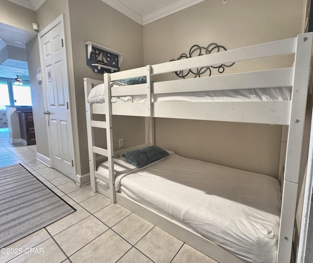 unfurnished bedroom featuring tile patterned floors, ornamental molding, and baseboards