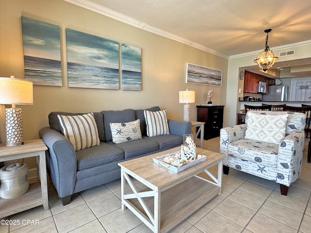 living room featuring light tile patterned flooring, visible vents, and ornamental molding