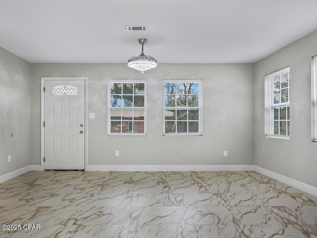 interior space featuring visible vents, a healthy amount of sunlight, marble finish floor, and baseboards