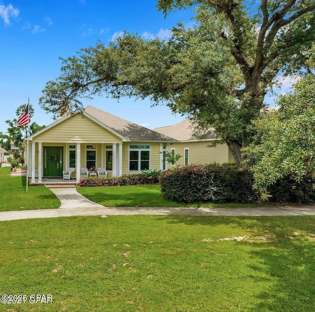 view of front of property with a porch and a front lawn