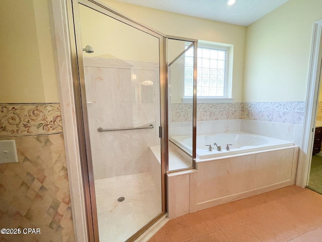 4004 Riverside Dr, Panama City, FL 32404 - bathroom featuring a garden tub, a shower stall, a wainscoted wall, and tile patterned flooring