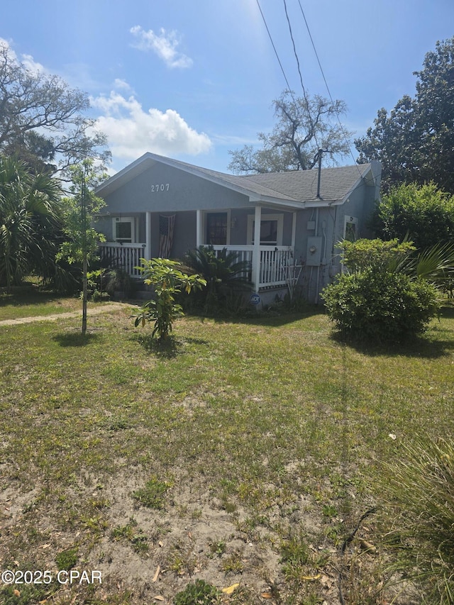 2707 W 18th St, Panama City, FL 32405 - back of house featuring covered porch and a yard