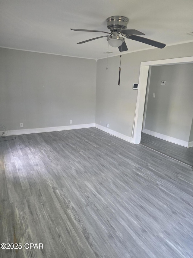 2707 W 18th St, Panama City, FL 32405 - spare room with baseboards, a ceiling fan, and dark wood finished floors