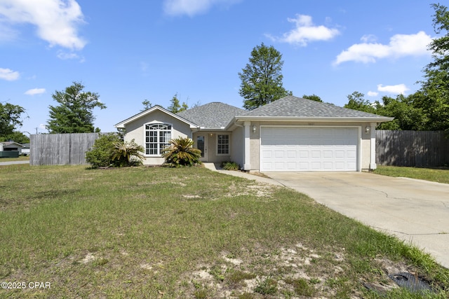 ranch-style home featuring an attached garage, fence, driveway, and a front lawn