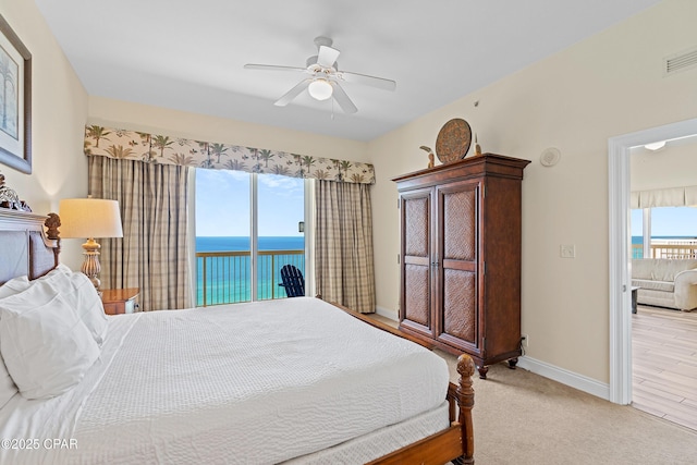 15817 Front Beach Rd Unit I-2309, Panama City Beach, FL 32413 - bedroom with a water view, access to outside, a ceiling fan, and light carpet