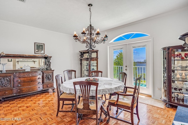 dining area with crown molding, baseboards, an inviting chandelier, and french doors